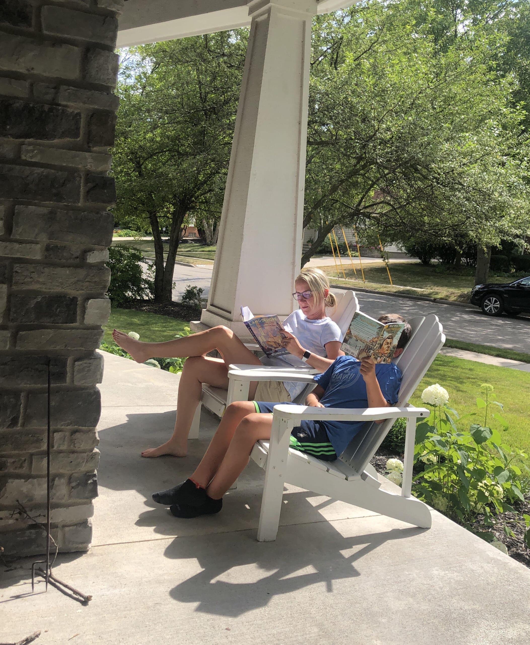students reading on front porch