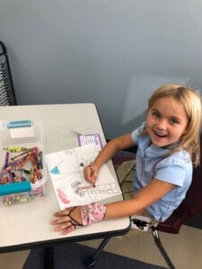 Kindergarten Student coloring a picture